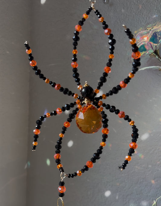 Orange and black spider suncatcher
