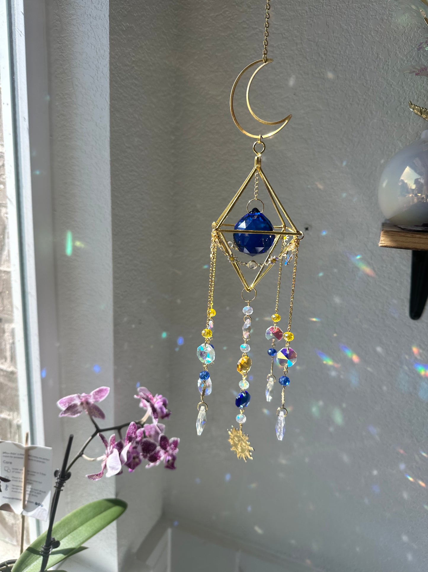 Blue and yellow “whimsygoth” celestial sun-catcher